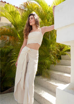Woman wearing the perfect linen set standing on a staircase with greenery in the background